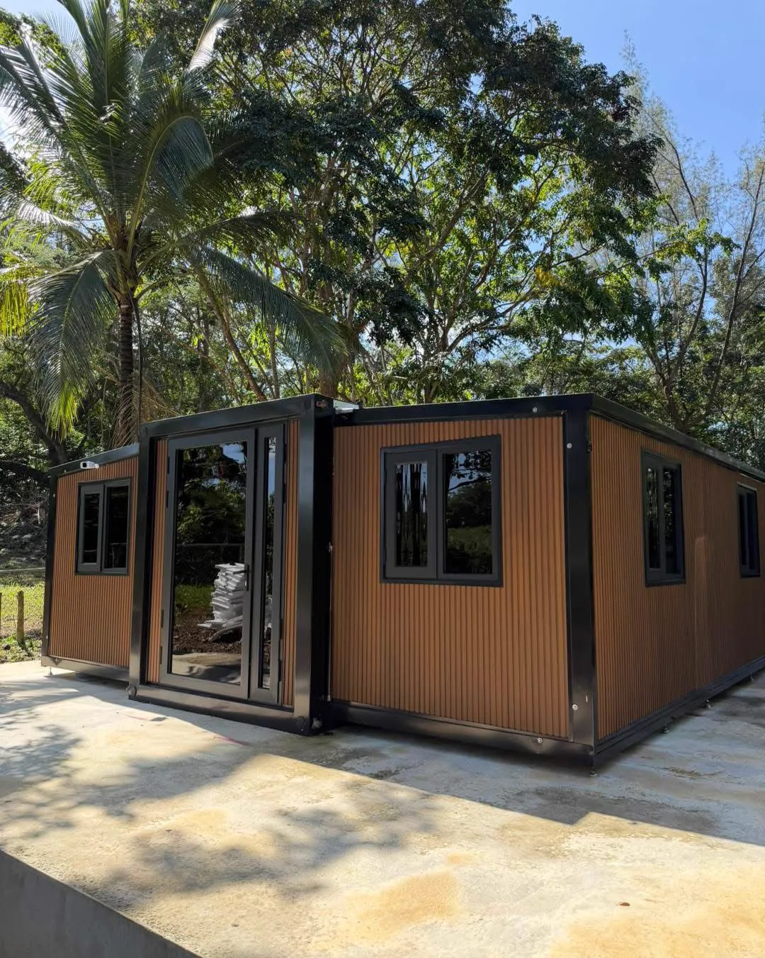 The Retreat, a long wood-clad THiNQ unit among palms